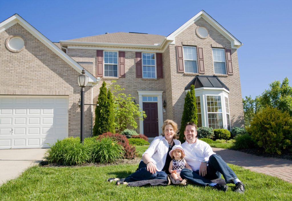 Family In Front Of House